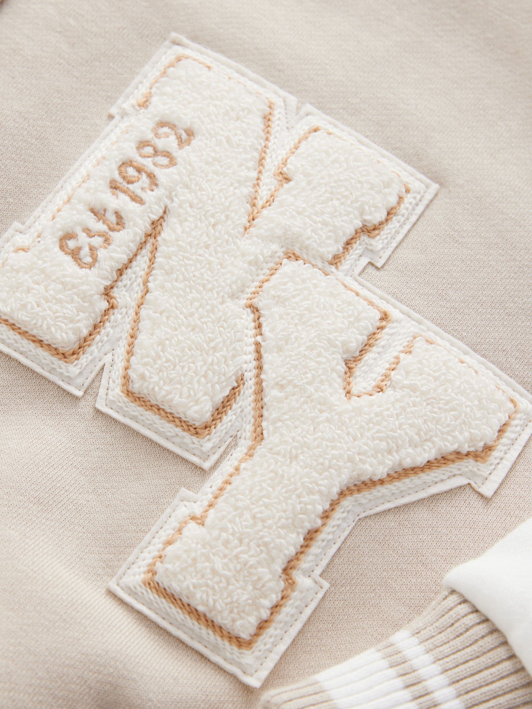 Beige boucle - Geborduurd Varsity-jasje (3 - 16 jr)