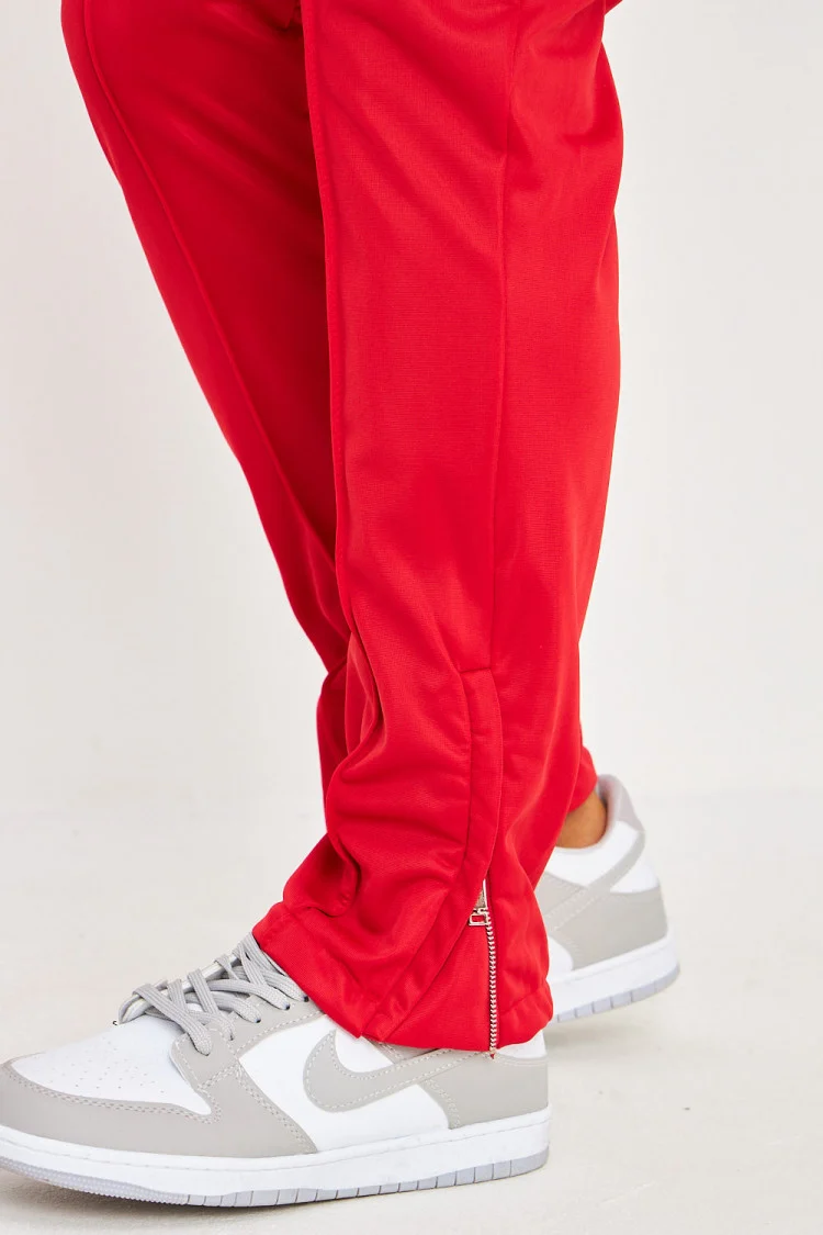 Pantalon de jogging rouge satiné zippé aux chevilles