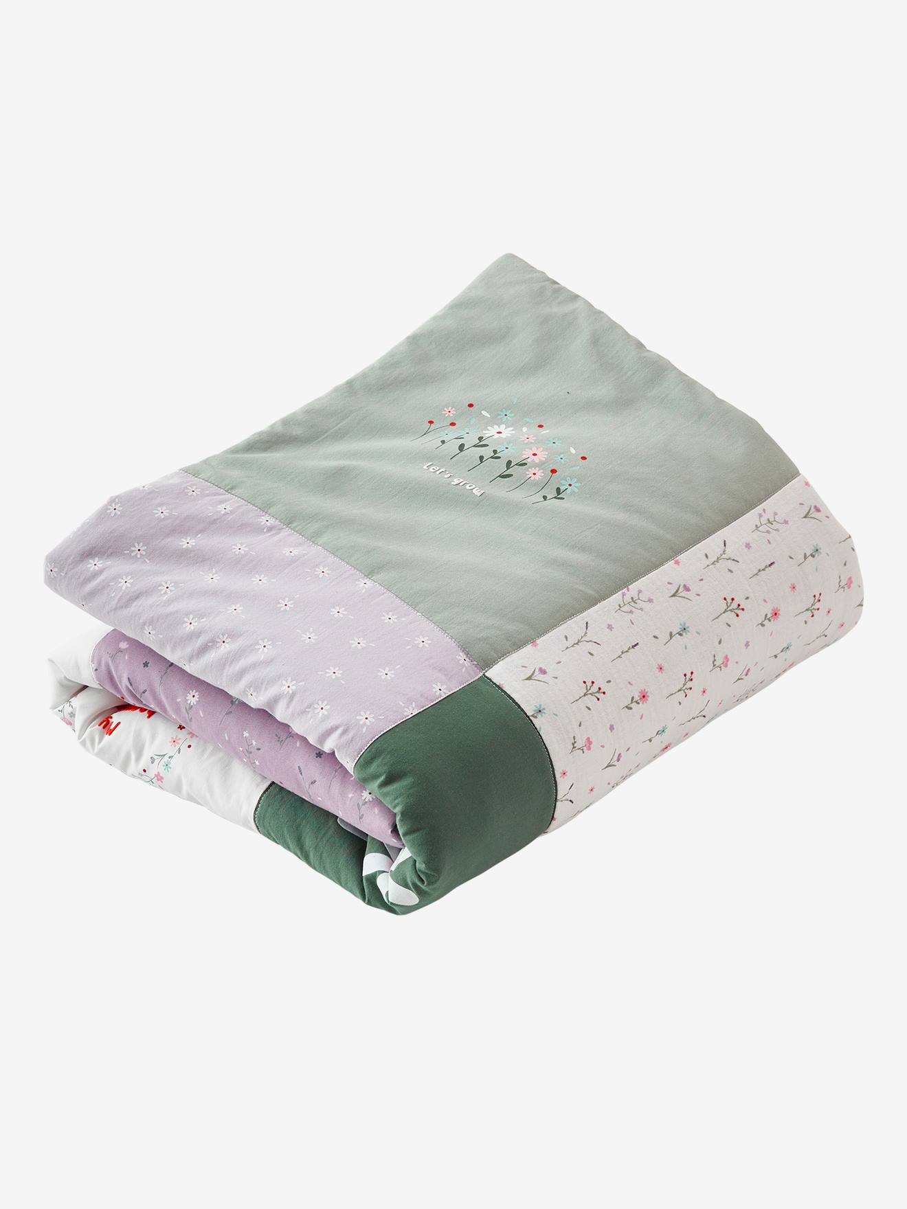 Colcha de retalhos Sweet Provence, lisa em tom violeta médio com motivos.