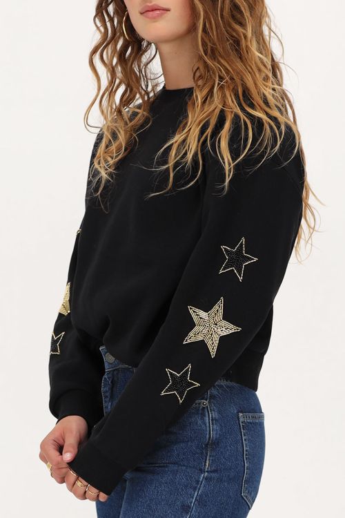 Zwarte sweater met goudkleurige sterren