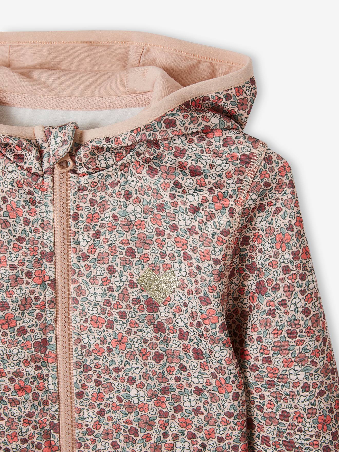 Conjunto de moletom com zíper e estampa floral, confeccionado em tecido técnico rosa estampado.