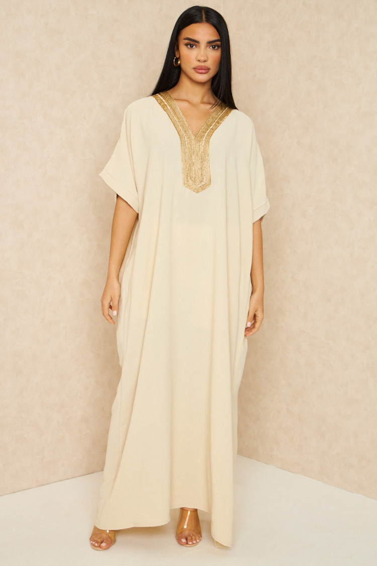 Abaya beige clair à broderies dorées