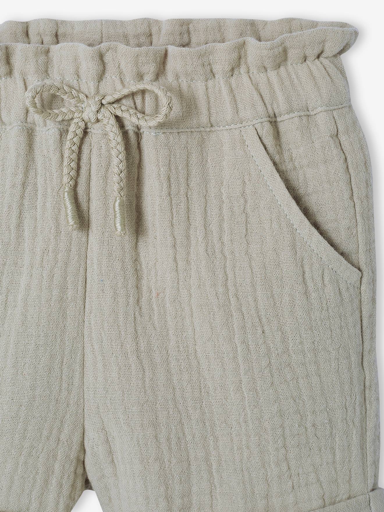 Calções de bebé com cintura elástica em chiffon de algodão liso cor laranja claro.