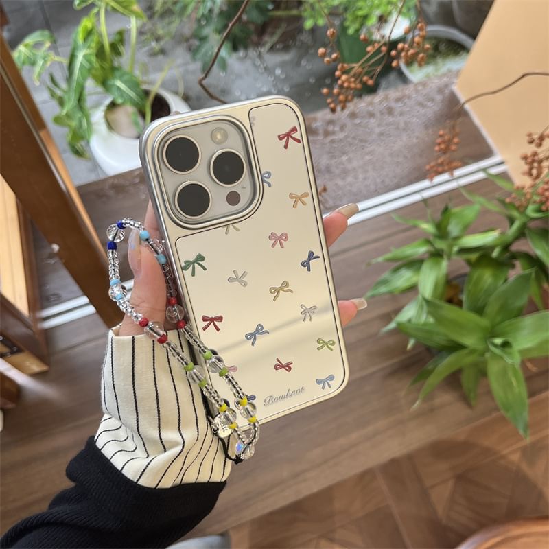 Elliure - Bow Mirrored telefoonhoesje / bandje / set - iPhone 16 Pro Max / 16 Pro / 16 Plus / 16 / 15 Pro Max / 15 Pro / 15 Plus / 15 / 14 Pro Max / 14 Pro / 14 Plus / 14 / 13 Pro Max / 13 Pro / 13 / 13 Mini
