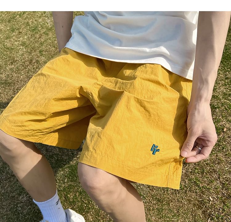AXEN - Wijde shorts met geborduurde letters en middelhoge taille
