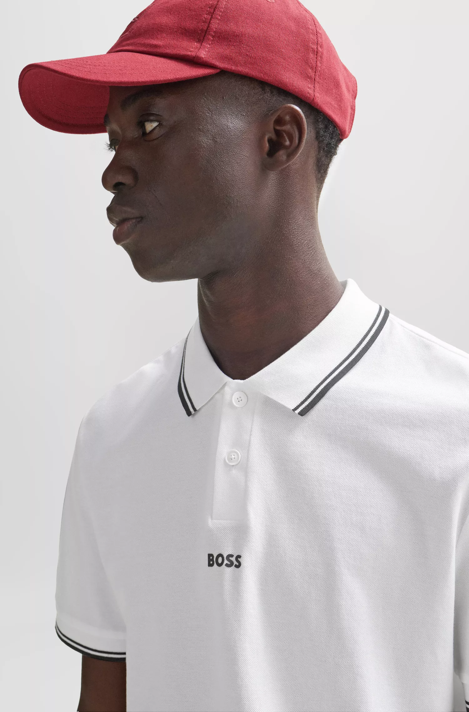 Camisa polo BOSS laranja em piqué de algodão com logotipo e detalhes contrastantes.
