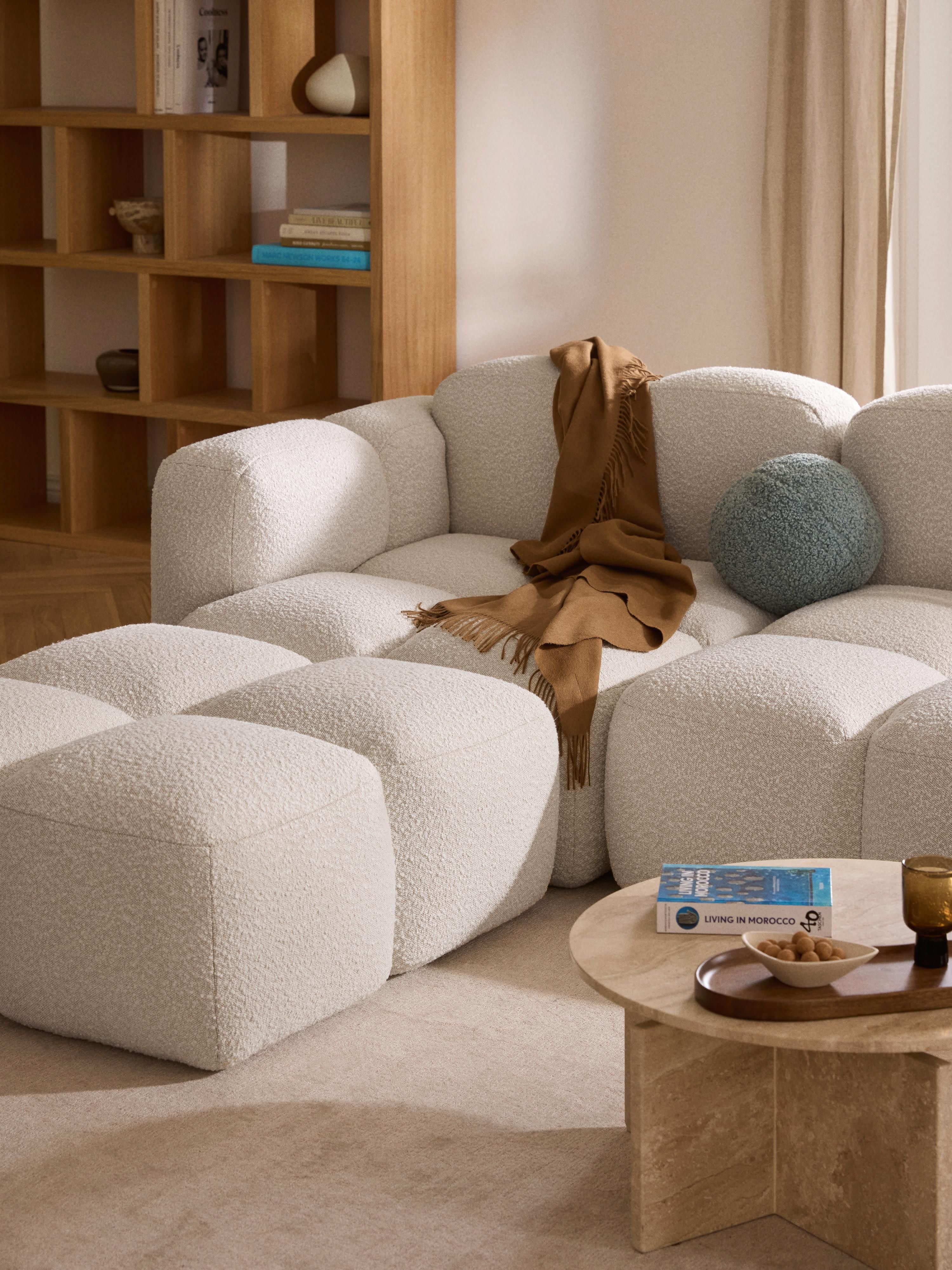 Modulaire bank Tayla (4-zits) van bouclé met poef (links/rechts)