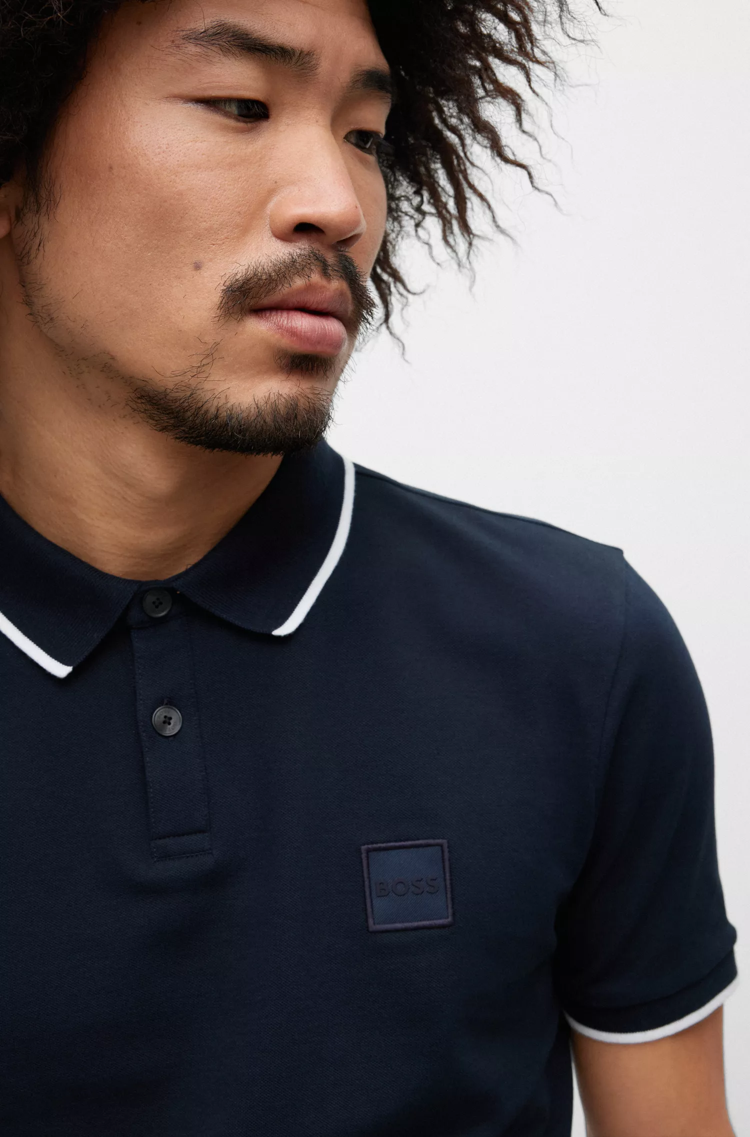 Camisa polo BOSS laranja, de algodão stretch, corte slim, com etiqueta de logotipo.