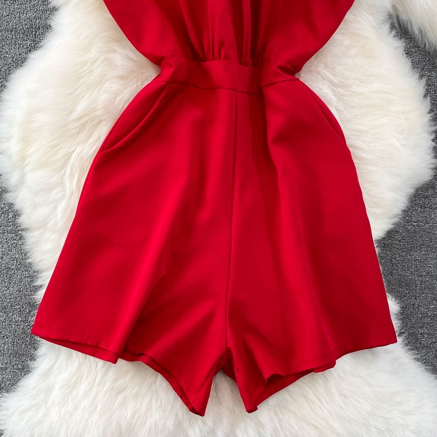 Yearnin - Mouwloze halter romper met wijde pijpen