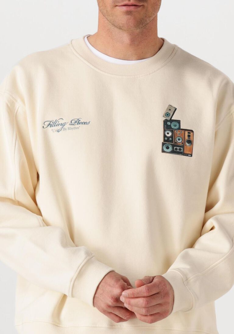 creme filling pieces sweater sweatshirt speaker wall