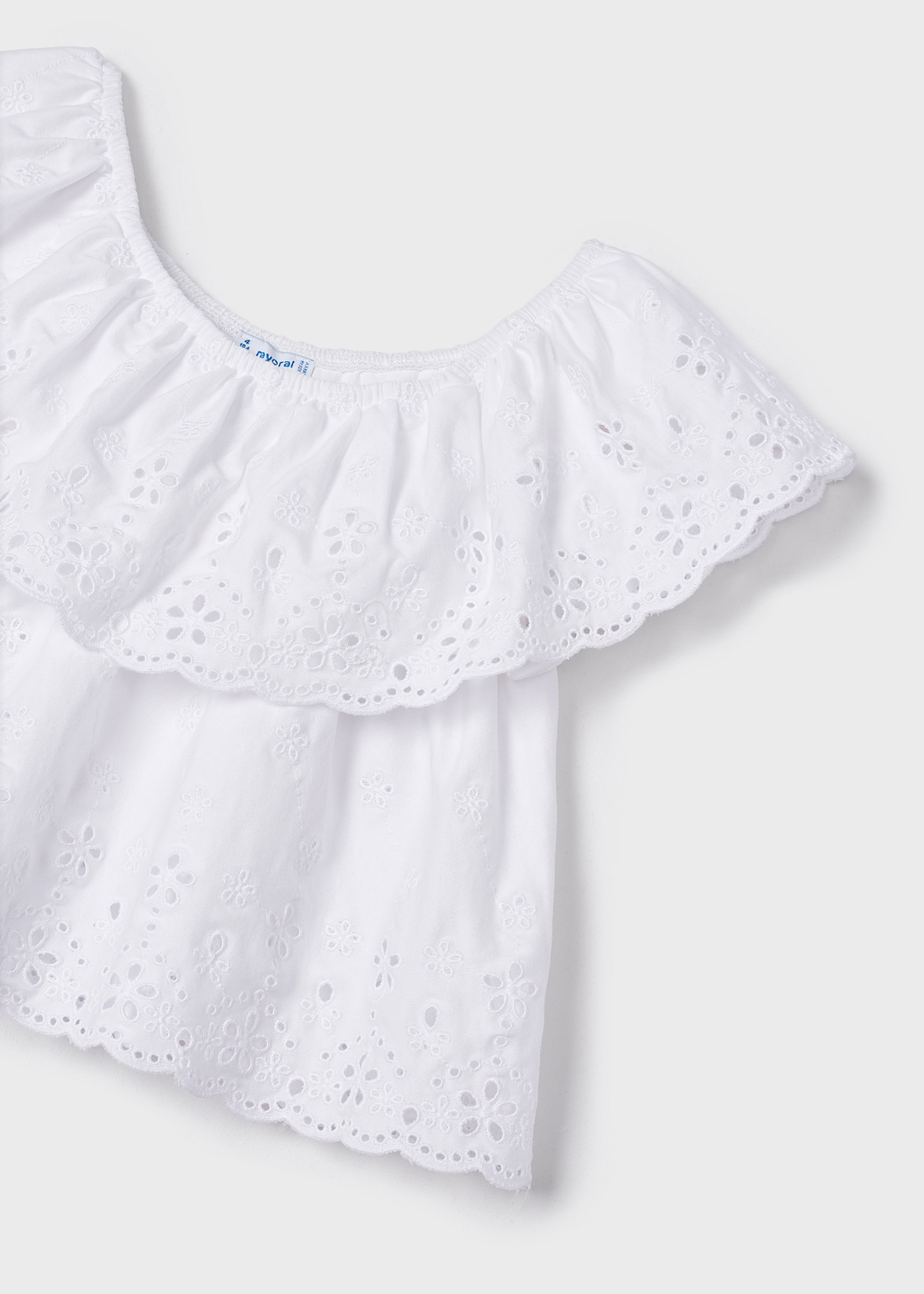 Blusa com motivos perfurados, feita de algodão sustentável, para meninas.