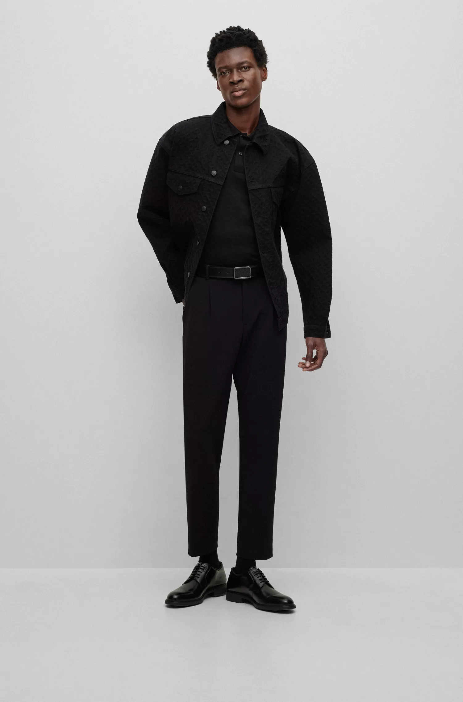 Camisa polo BOSS preta, corte regular, com jacquard de monograma.