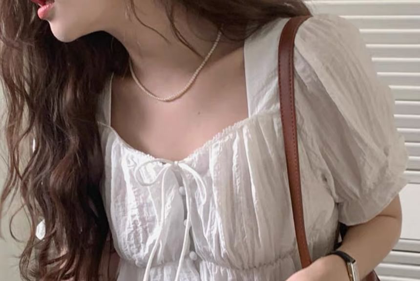 minaga - Effen blouse met kanten rand en pofmouwen