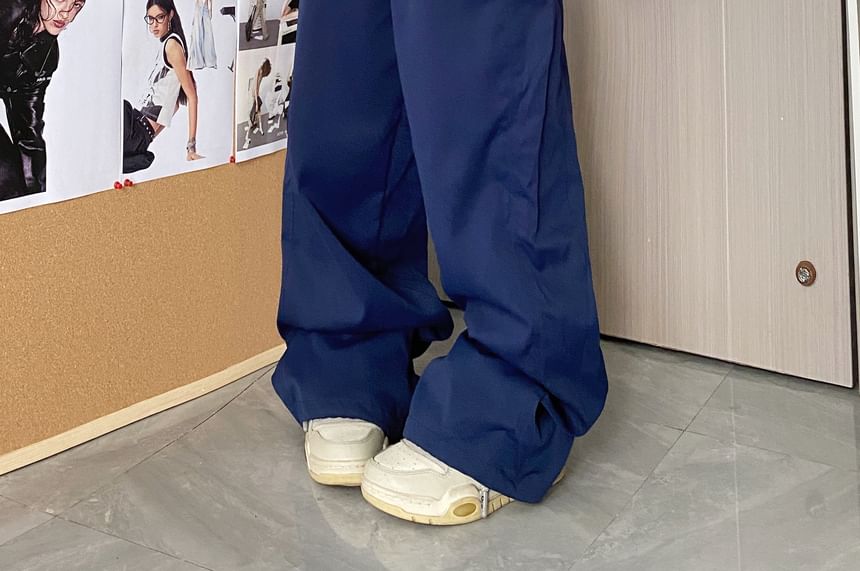 MELLO - Wijde broek met middelhoge taille en geruit paneel en letters