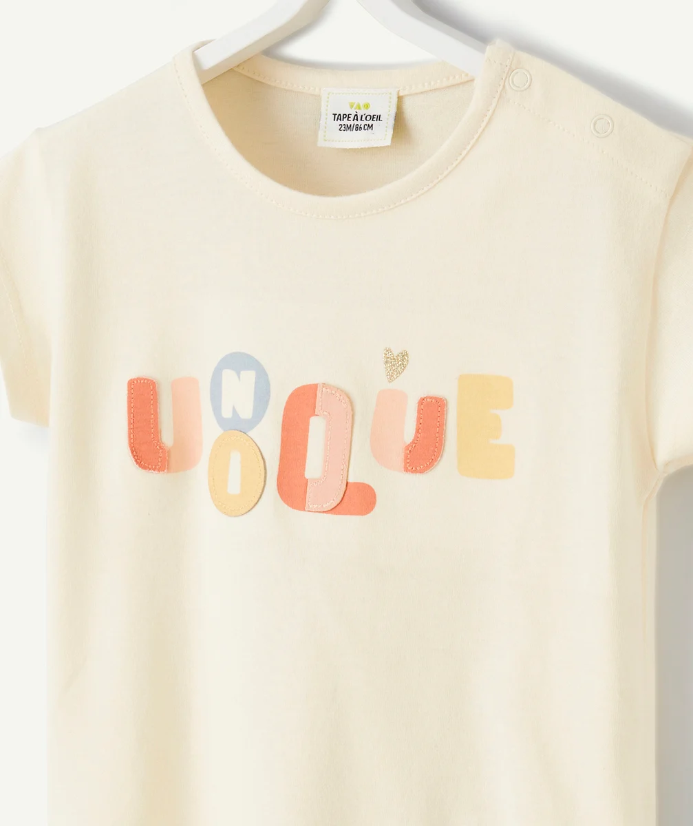 T-SHIRT BÉBÉ FILLE EN COTON BIO ÉCRU AVEC MESSAGE COLORÉ