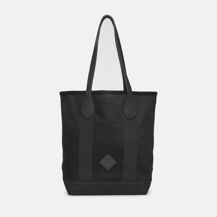 Bolsa tote feminina em lona e couro na cor preta.