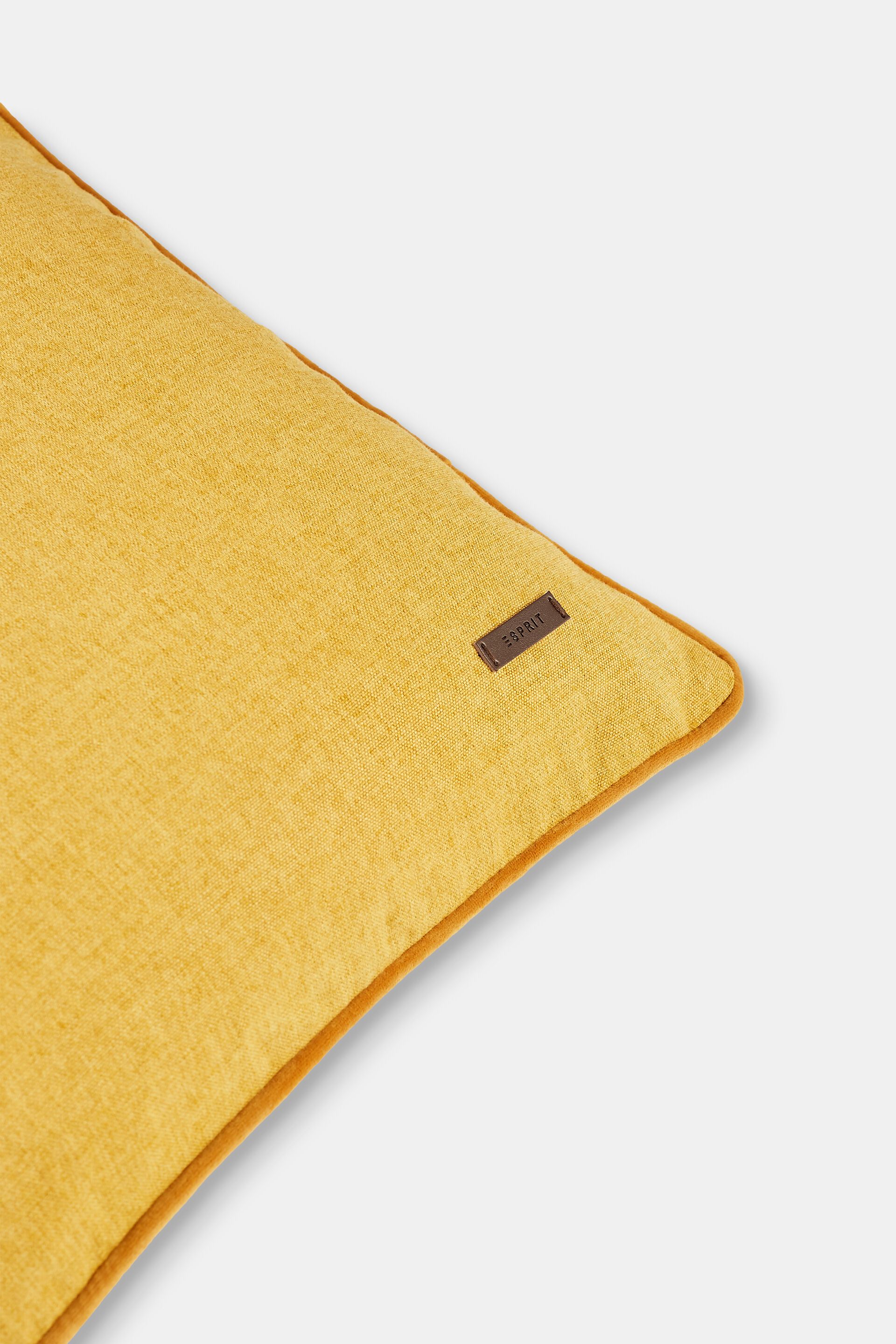 Housse de coussin décorative rehaussée d’un passepoil en velours