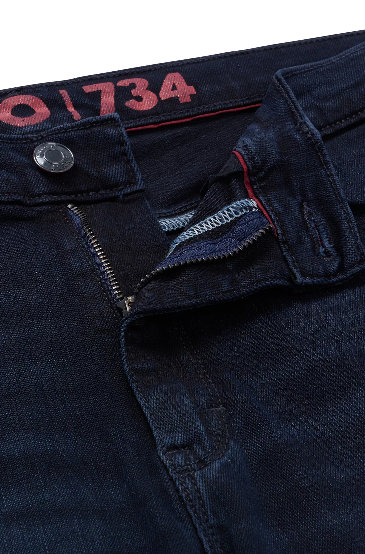 Calça jeans HUGO vermelha, extra slim fit, em denim stretch azul-preto.