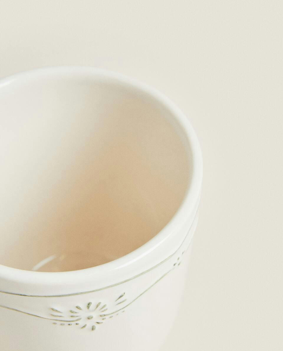 Caneca de barro com desenho natalino em relevo