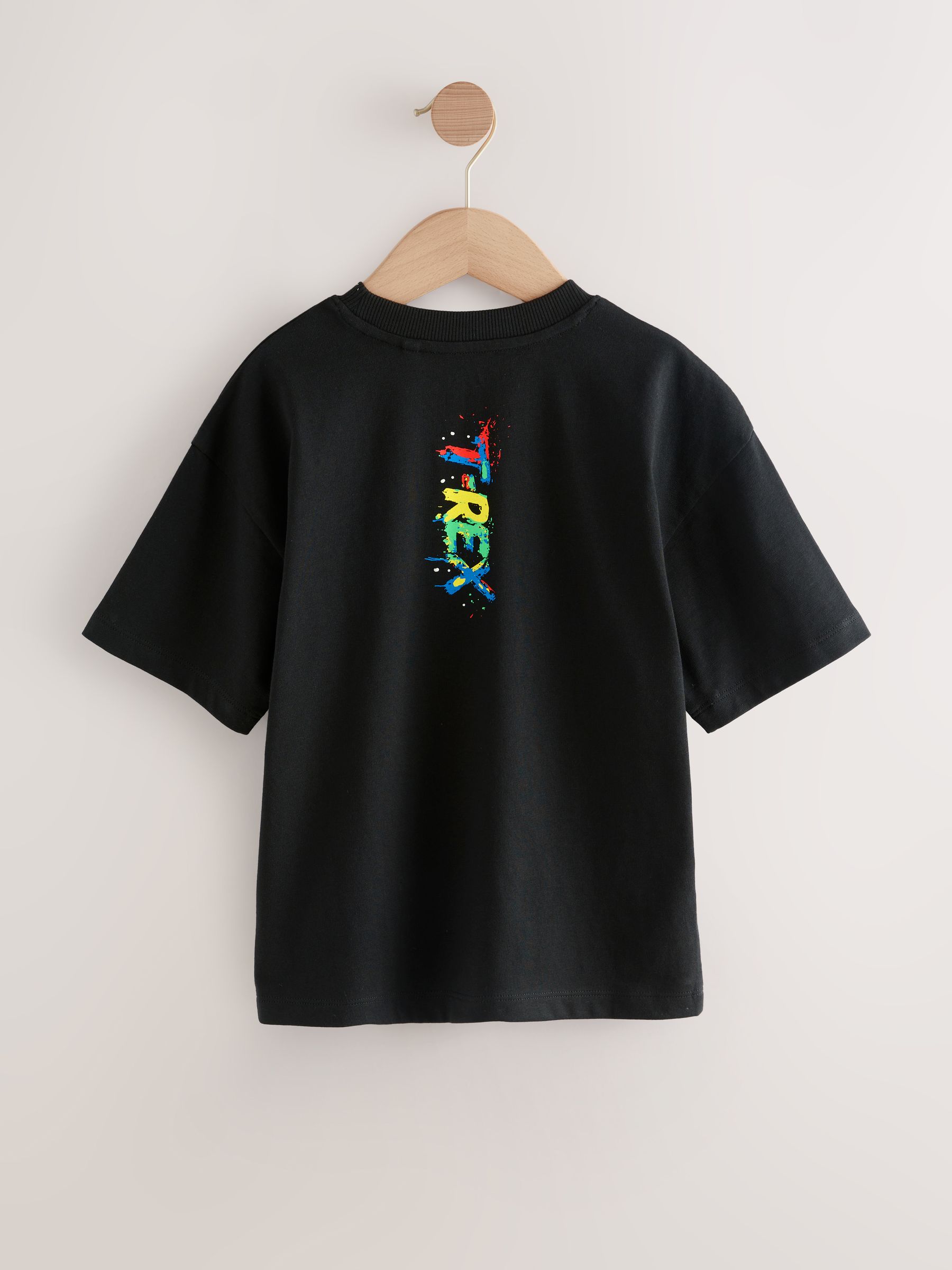 Zwart/Meerkleurig Dino - Ruimvallend T-shirt met print en korte mouwen (3-16 jr)