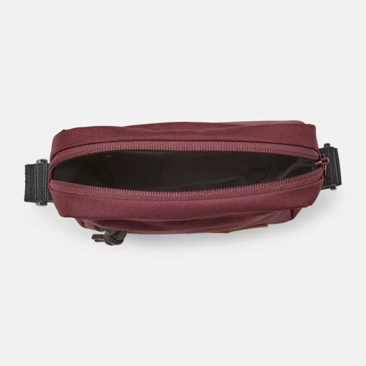 Bolsa transversal Timberland Core, unissex, na cor bordô.