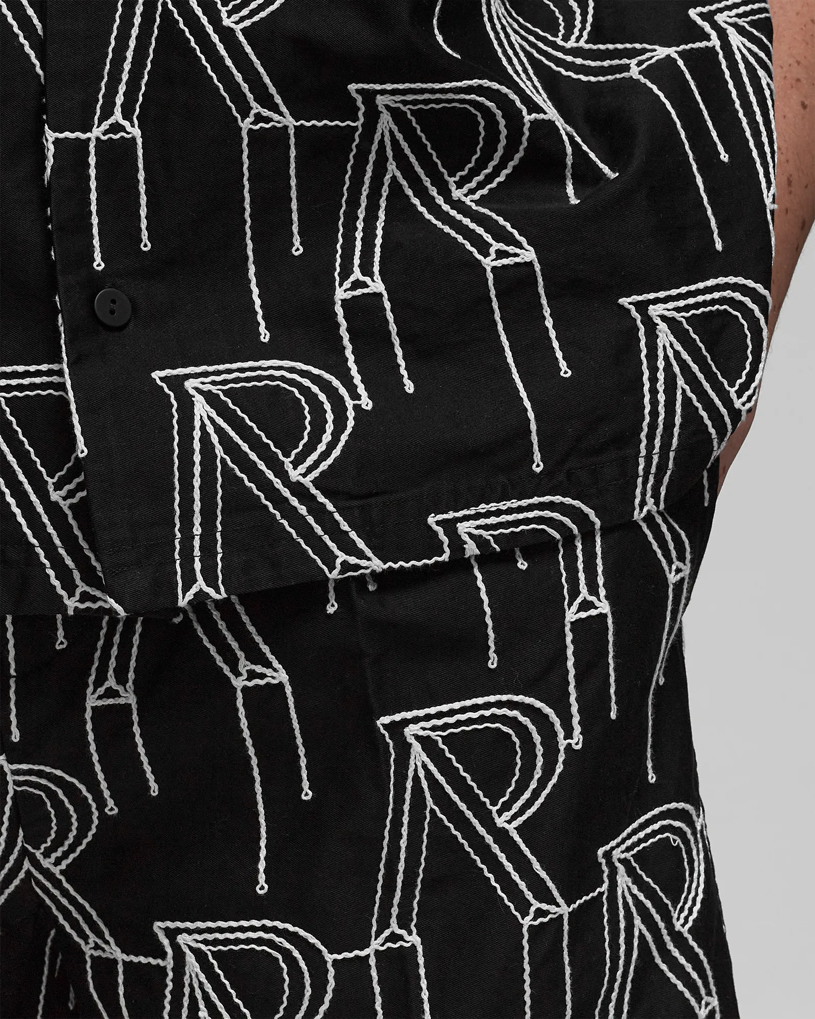 Represent EMBRODIERED INITIAL TAILORED SHORT