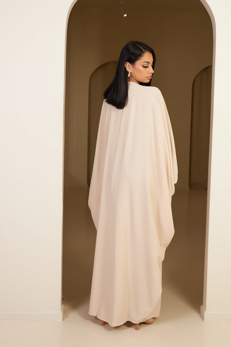 Abaya beige à empiècement sequins et pompom noir
