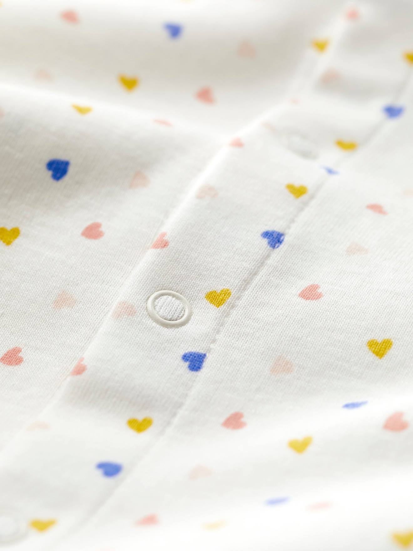 Macacão infantil PETIT BATEAU em algodão orgânico, branco claro com estampa.