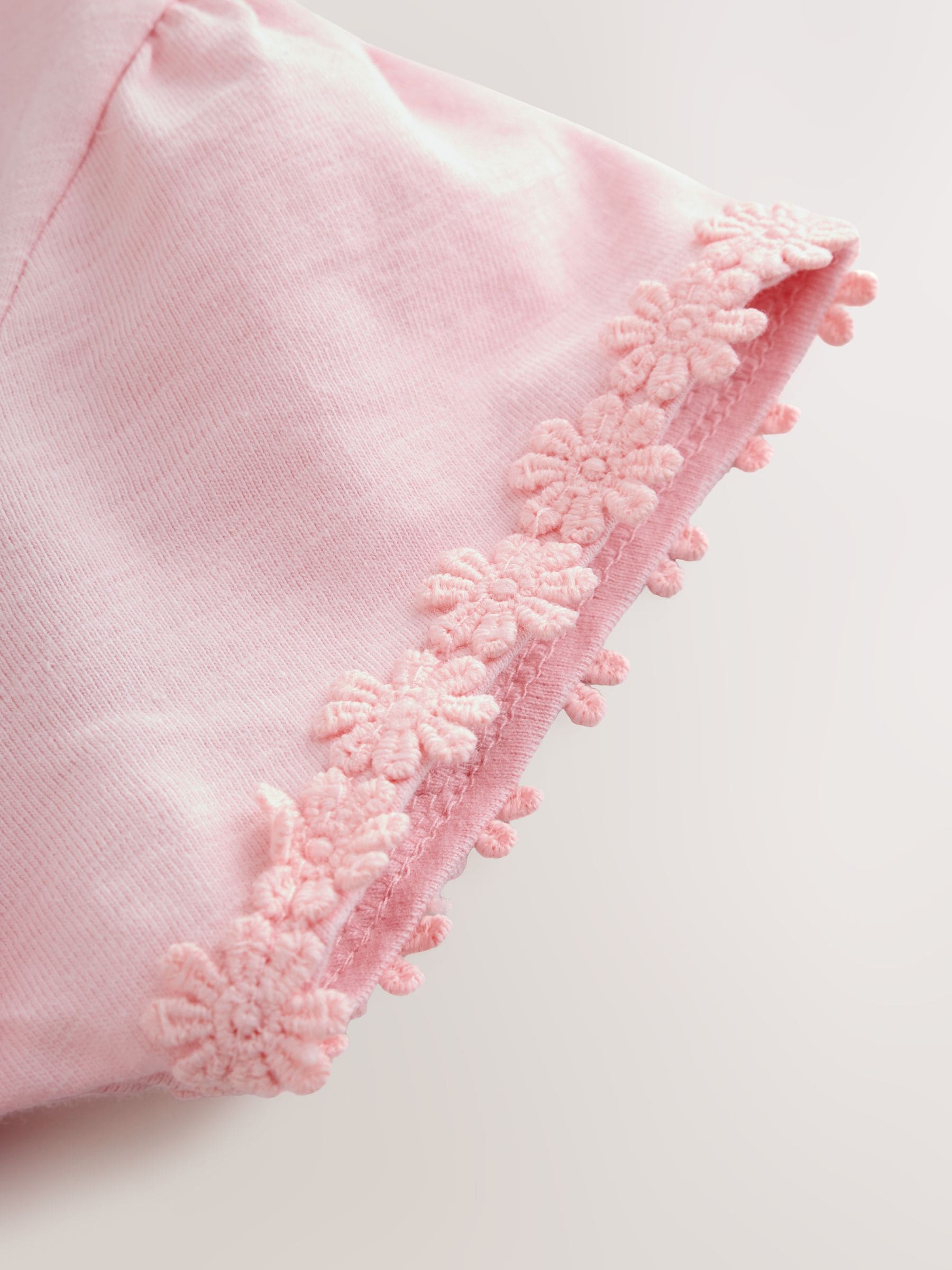 Roze - T-shirt met zakje en madeliefjesprint (1,5-16 jr)