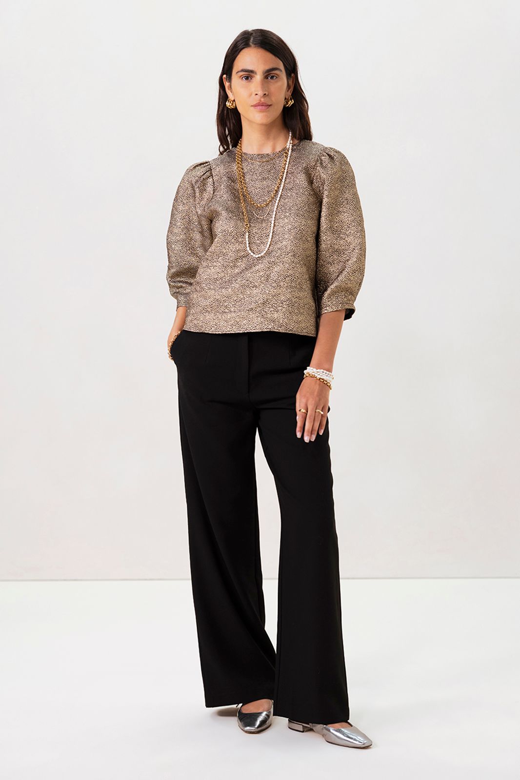 Gouden metallic top met strikdetails