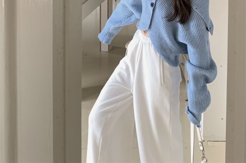 Letme - Effen coltrui met knoopjes en cropped mouwen