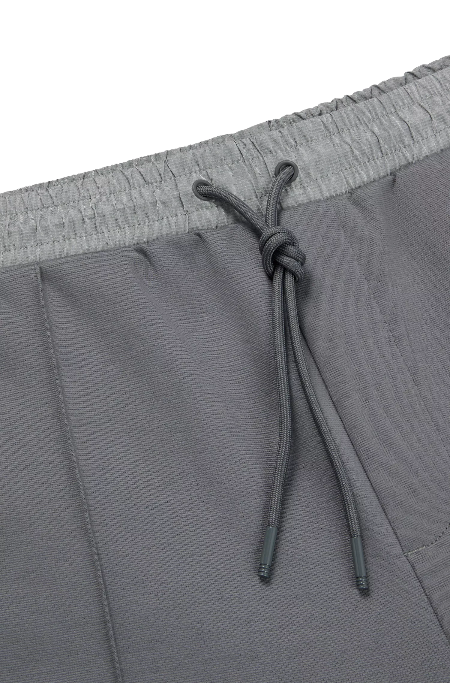 Calça de fato de treino BOSS em mistura de algodão verde com detalhes pixelados.