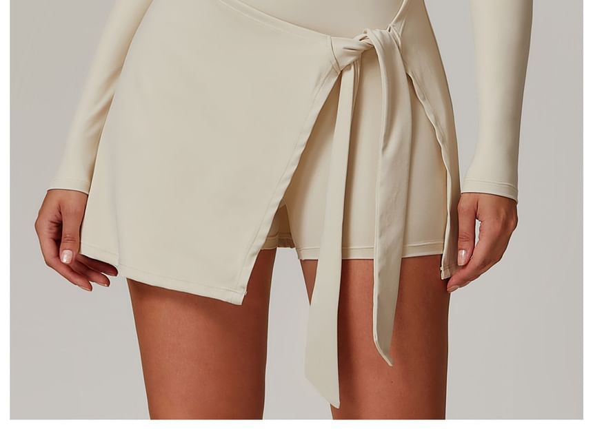 Skinniano - Sportromper met lange mouwen, ronde hals, effen rok en overlay