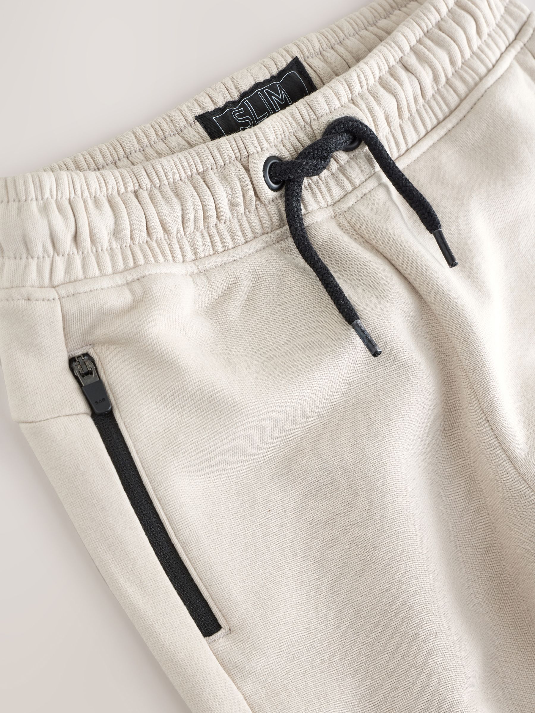 Steen/grijs - Slim-fit joggingbroek met ritszak (3-16jr)
