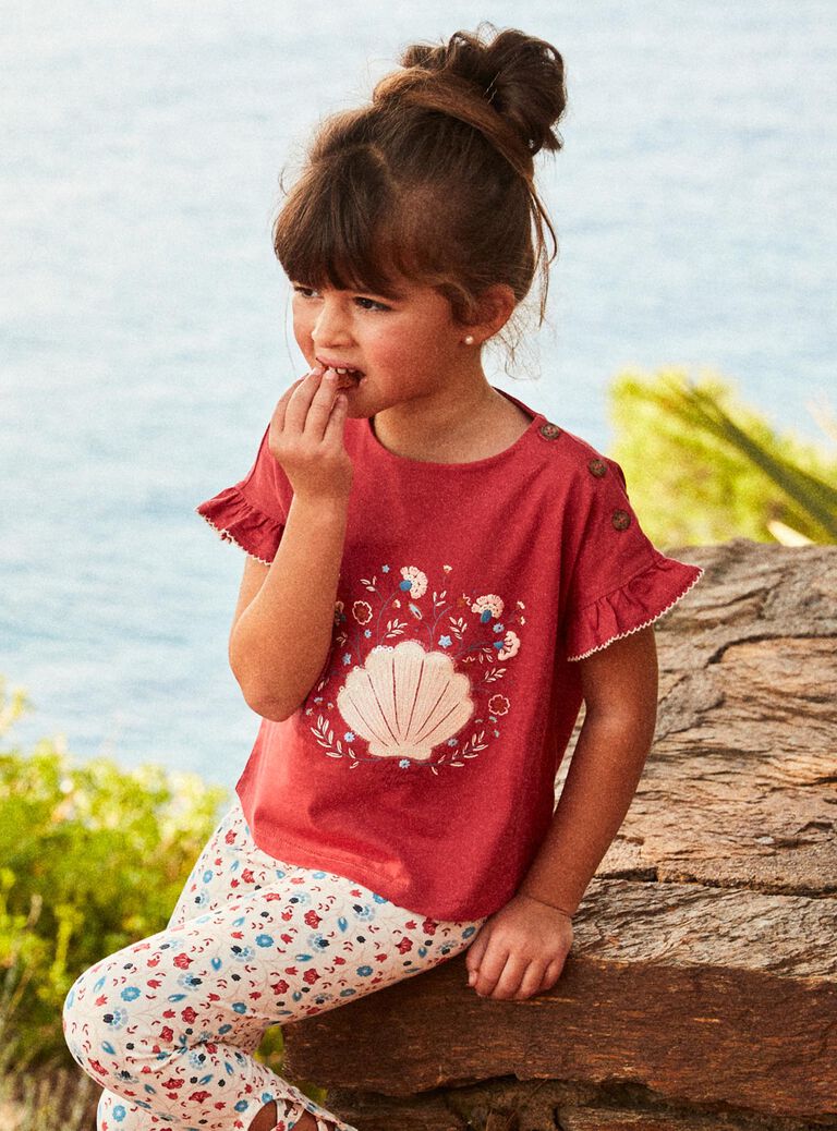 T-shirt rouge avec coquillage en sequins et petit sac fantaisie