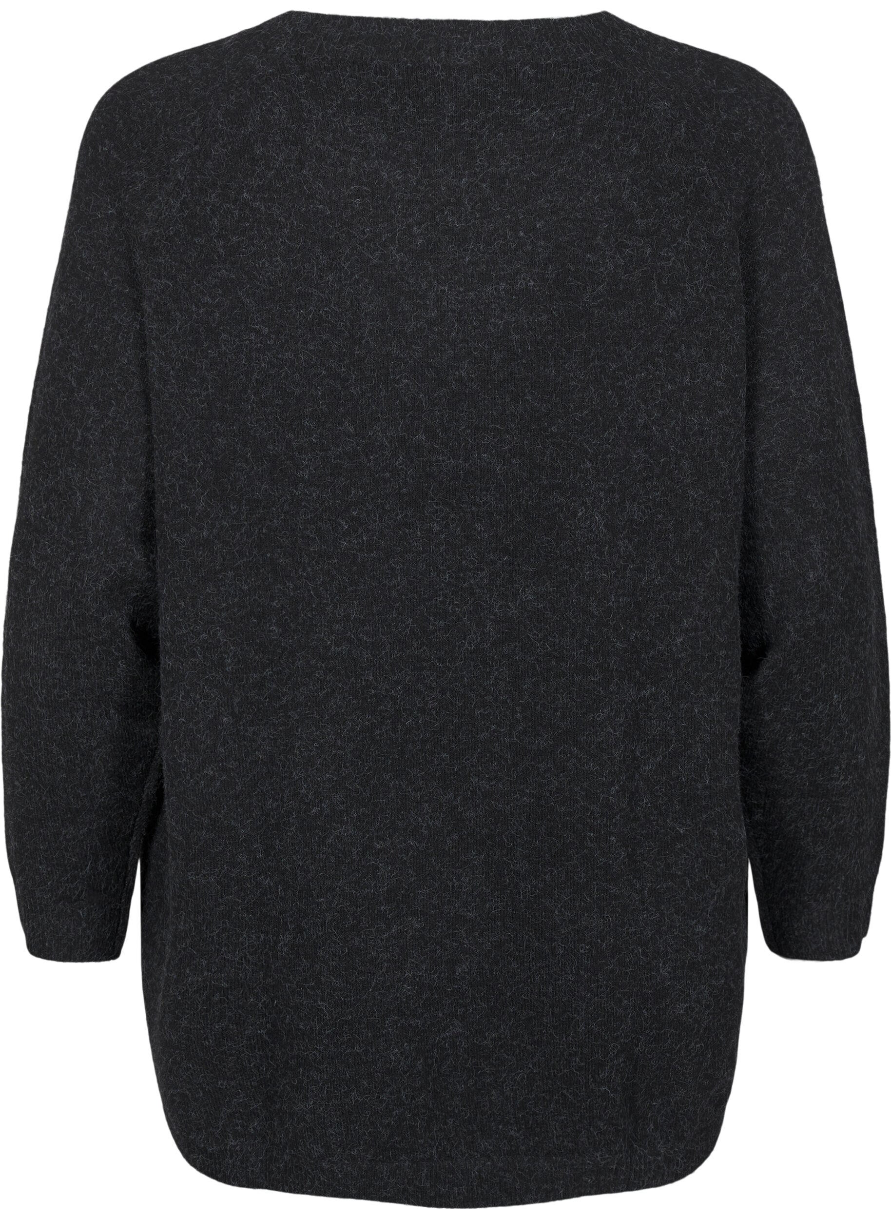 Strikbluse med perledetaljer