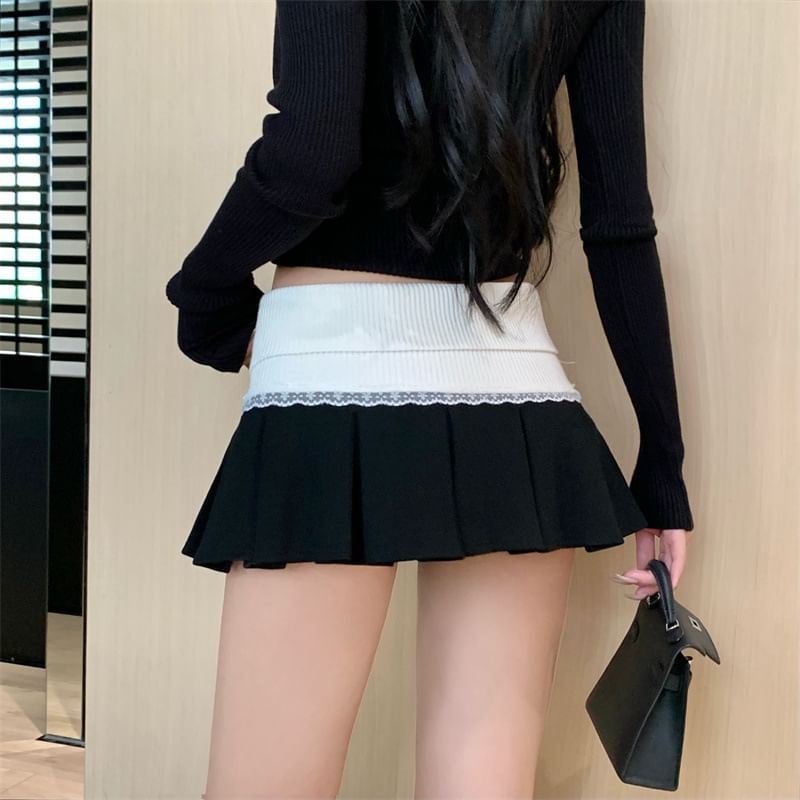 Rosesand - Mini geplooide rok met lage taille, kleurvlakken en kantafwerking
