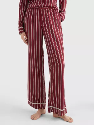 Calças de pijama com listras e logotipo em tom sobre tom