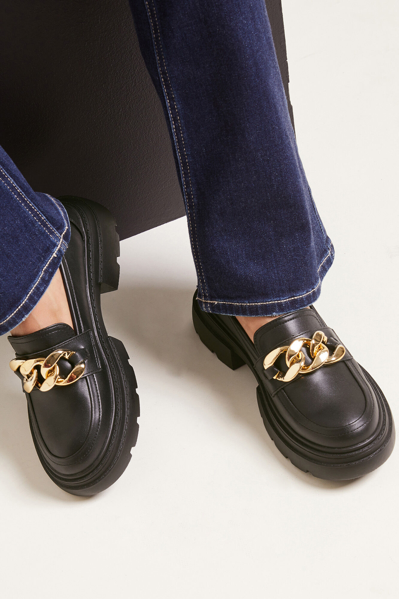 Mocassins robustos em imitação de couro com fivelas douradas.