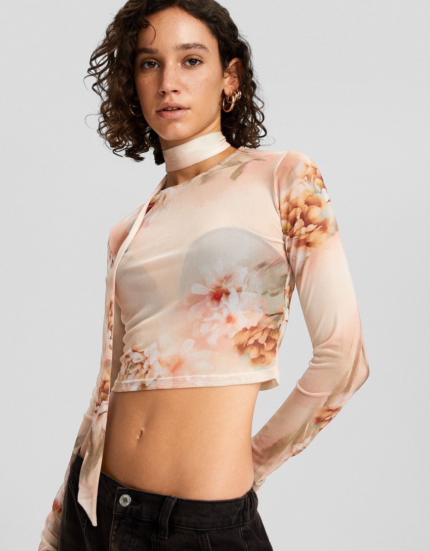 Camiseta de tule de manga comprida com estampa floral e lenço.