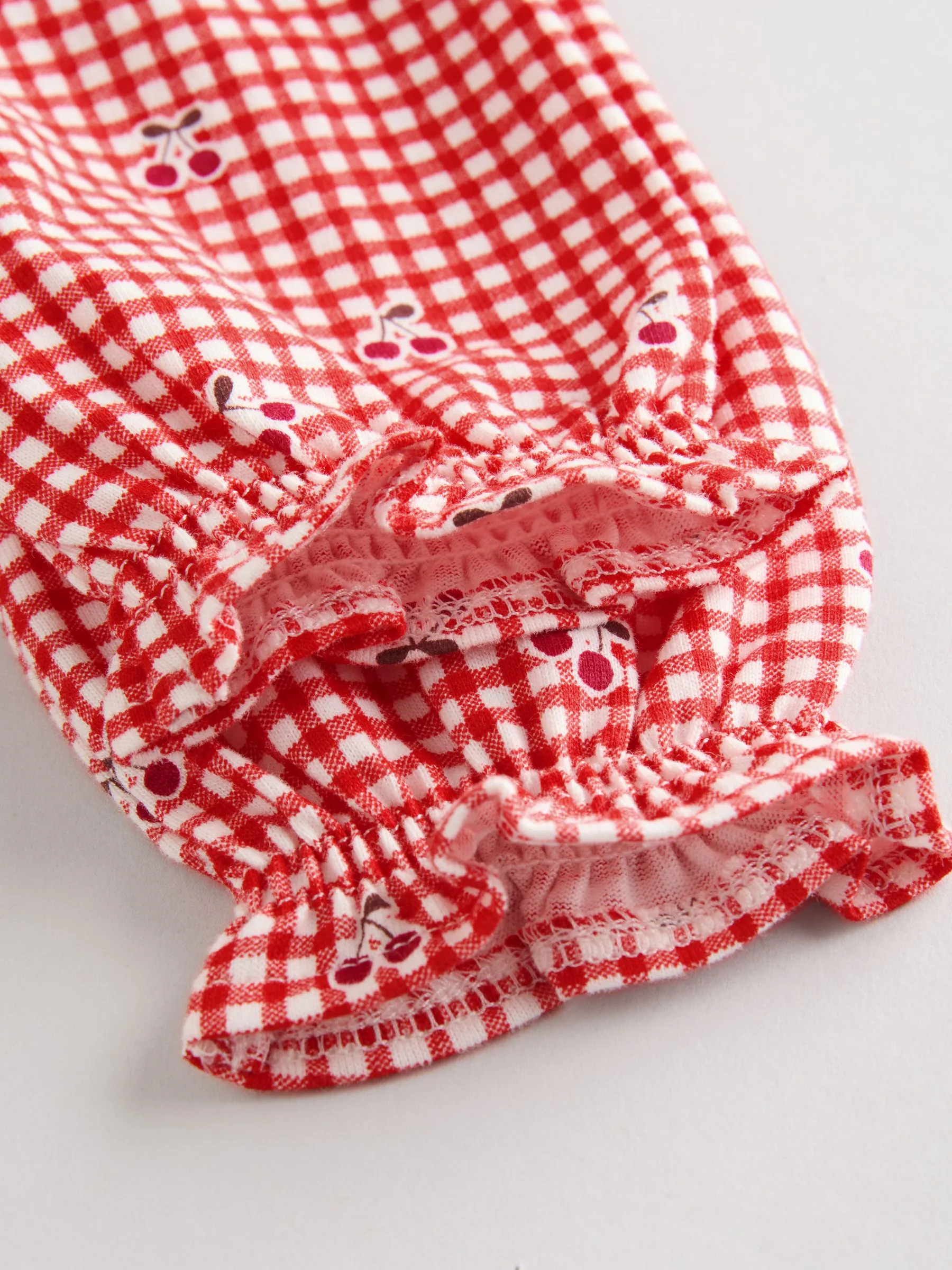 Crème beer/ rode kersen geruit - Verpakking van 2 jersey babyjurkjes (0 mnd-2 jr)