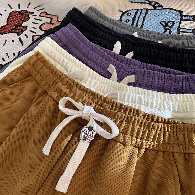 Kimeya - Sweatshorts met trekkoord en letterprint