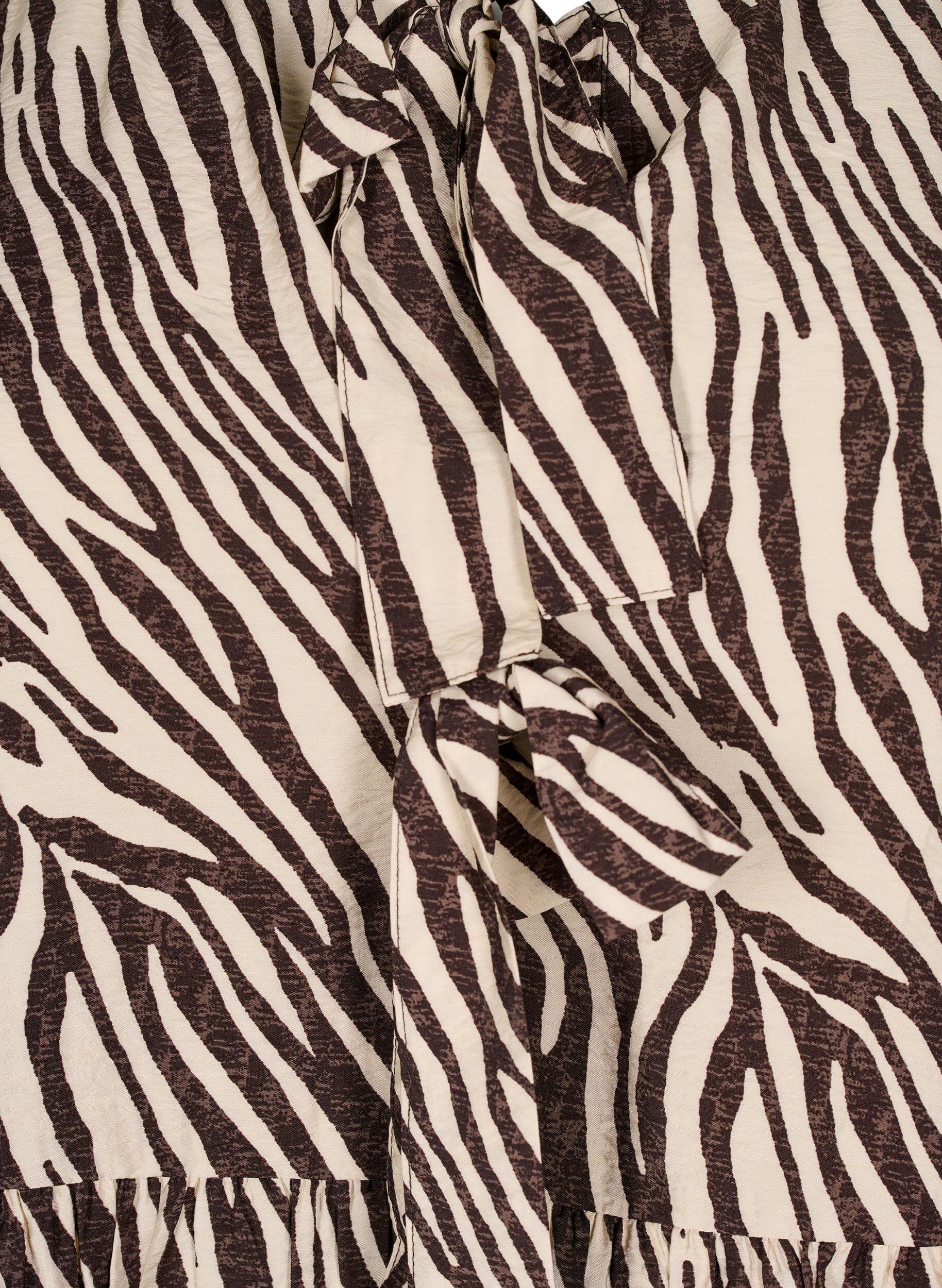 Peplumbluse med bindebånd og zebraprint