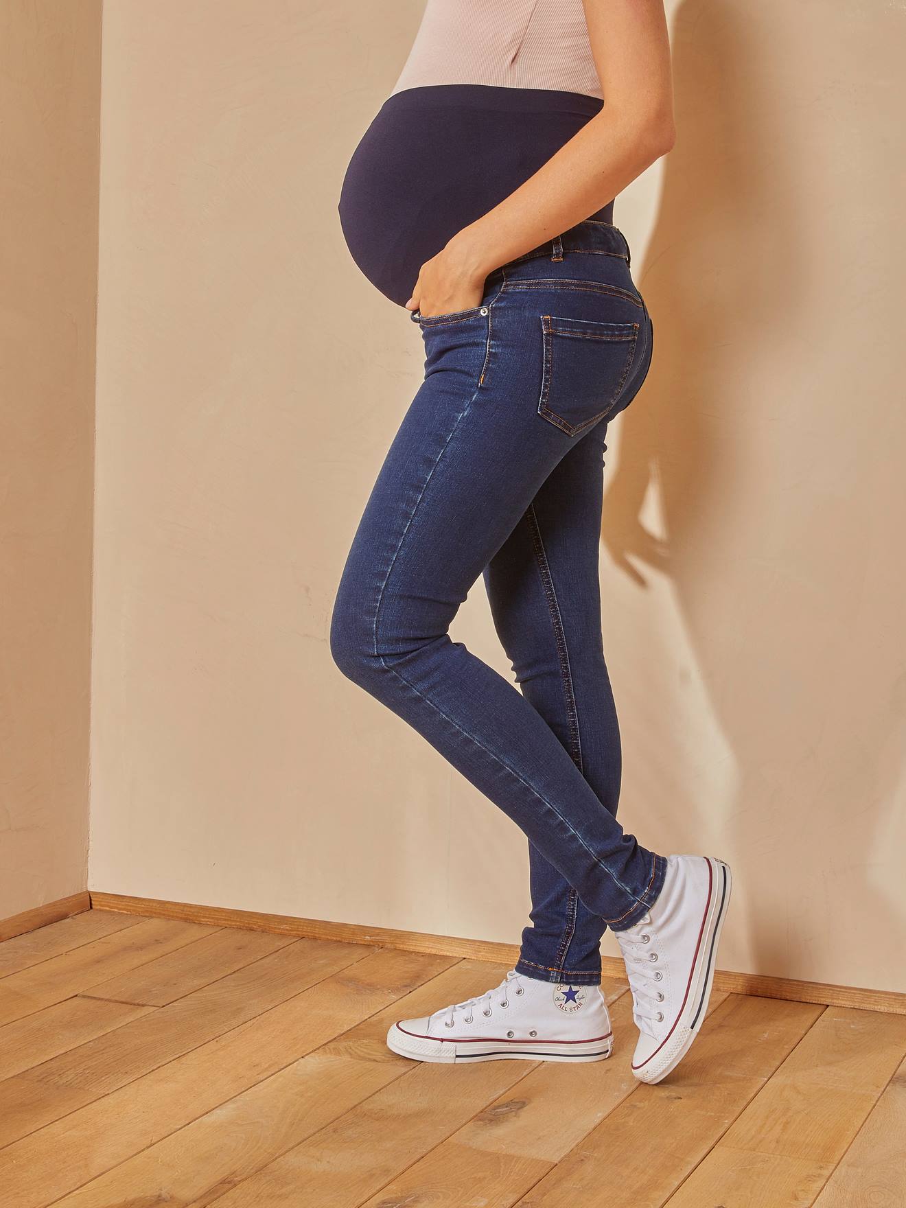 Calça jeans slim para gestantes com faixa lisa cinza-escura sem costura.