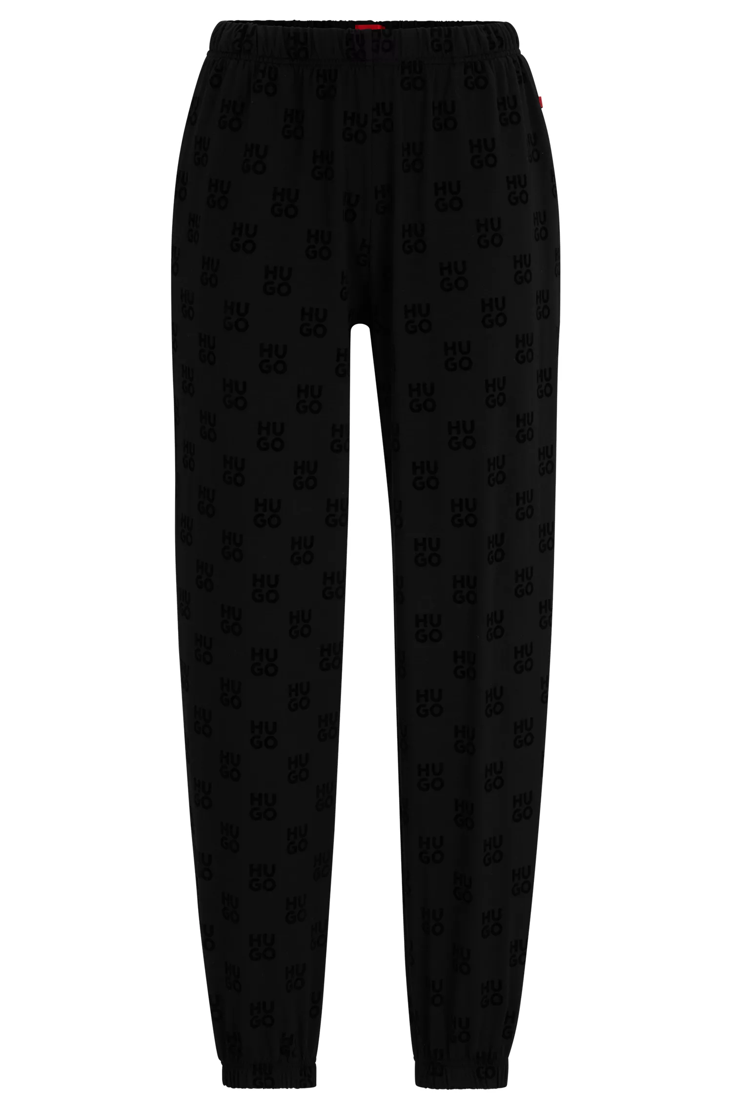 Calça de fato de treino HUGO vermelha em tecido elástico com logótipos sobrepostos.