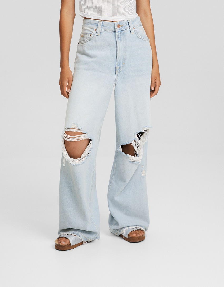 Jeans desbotados, rasgados e super folgados
