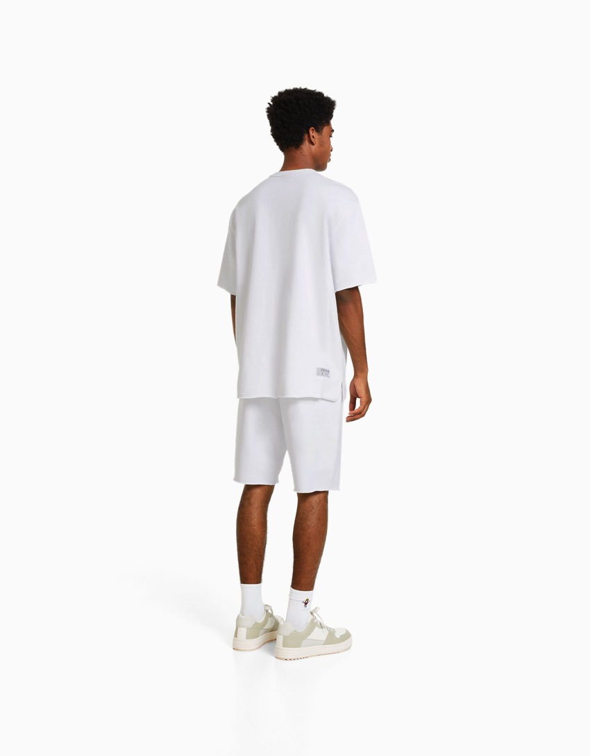Bermudas de pelúcia com efeito desbotado