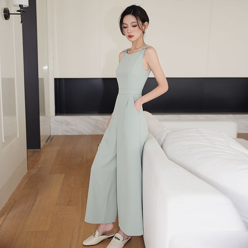Juuri - Mouwloze jumpsuit met boothals, strik en wijde pijpen