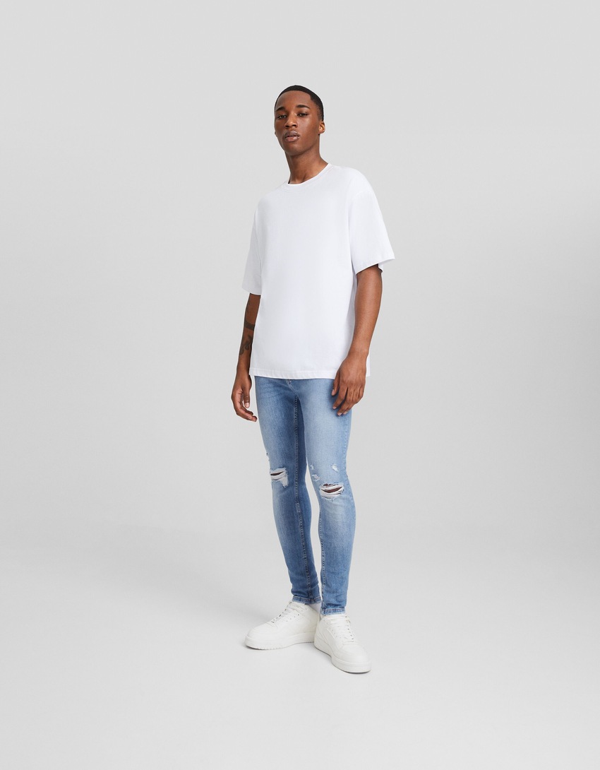 Calça jeans skinny rasgada