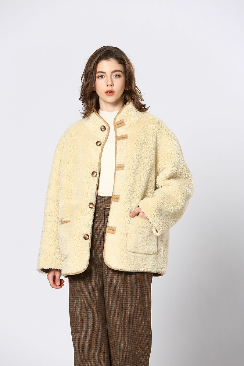 Vejo você em breve<br>Omkeerbare jas em sherpa